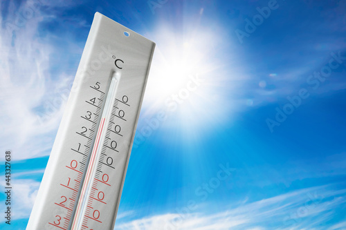 Weather thermometer with high temperature outdoors on hot sunny day. Heat stroke warning