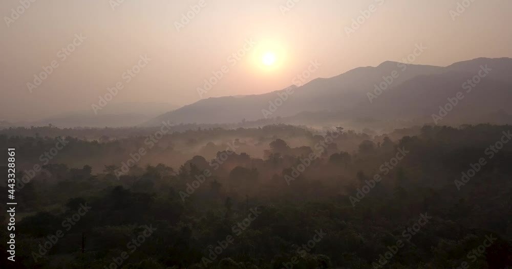 Golden Sunset Illuminated Over Mountainous Landscape With Thick Forest At Cotigao Wildlife Sanctuary In South Goa, India. - Aerial Wide Shot Golden Sunset Illuminated Over Mountainous Landscape With Thick Forest At Cotigao Wildlife Sanctuary In South Goa, India. - Aerial Wide Shot