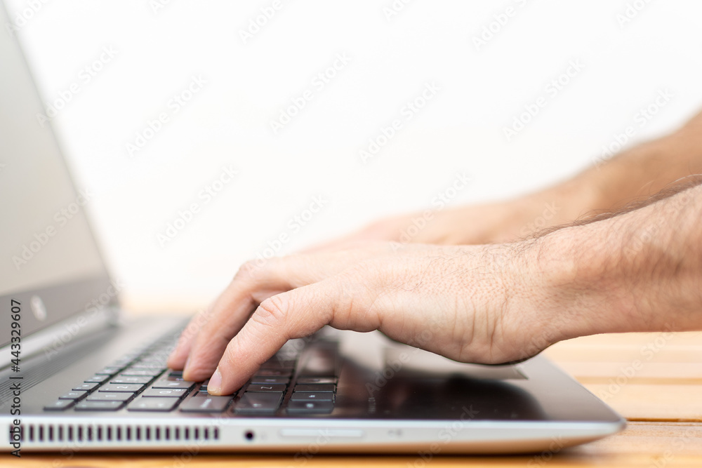Hands typing on a Laptop with blurred background Hands typing on a Laptop with blurred background