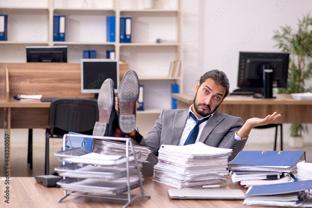 Young businessman employee unhappy with excessive work in the of Young businessman employee unhappy with excessive work in the of