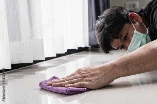 Construction man cleaning tile floor finishing using thinner