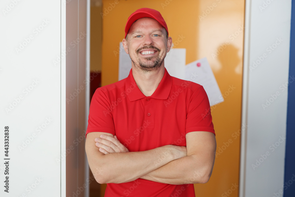 Portrait of smiling male courier in red uniform Portrait of smiling male courier in red uniform