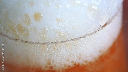 Detailed super slow motion footage of a beer. glass being filled up with lager beer. Foam builds up in a steady pace. Beer and beverage concept. photo