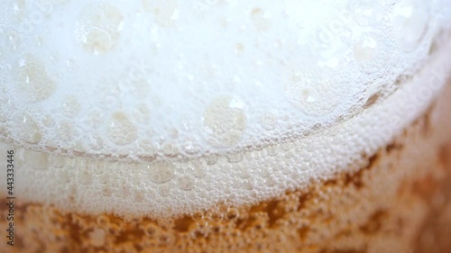 Amazing 4K footage of a beer. glass being filled up with lager beer. Foam and bubbles rise up in a steady pace.
Beer and beverage concept. photo