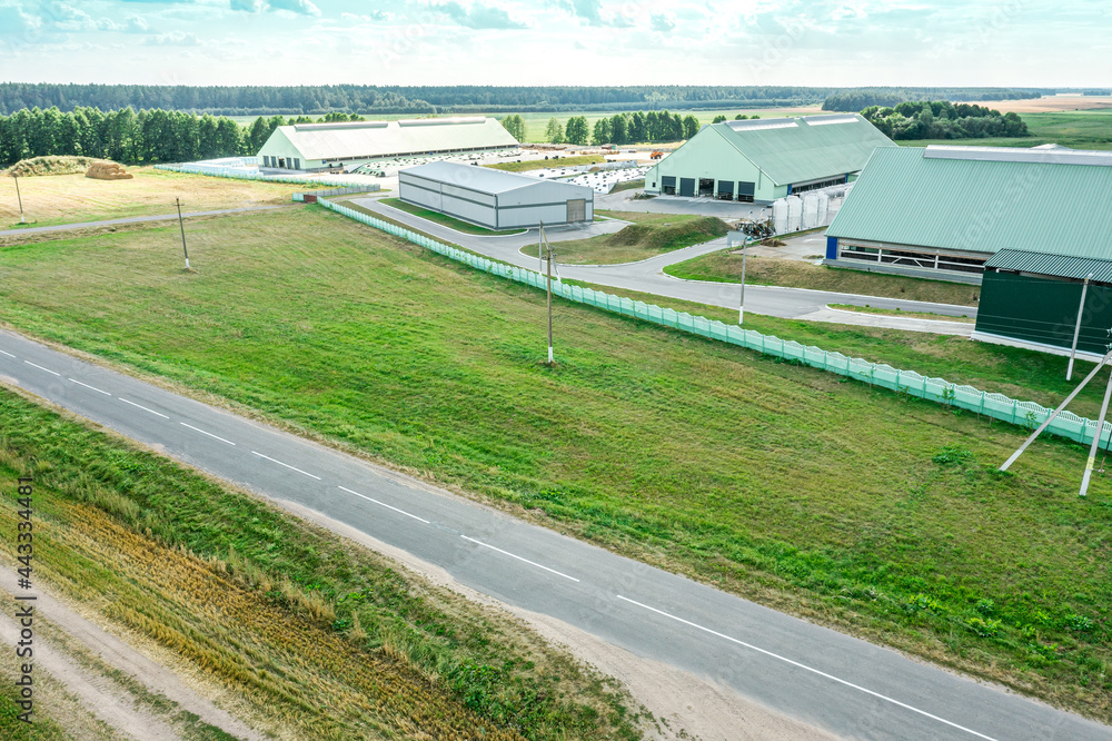aerial view of farm buildings and farmland in countryside. rural summer landscape. aerial view of farm buildings and farmland in countryside. rural summer landscape.