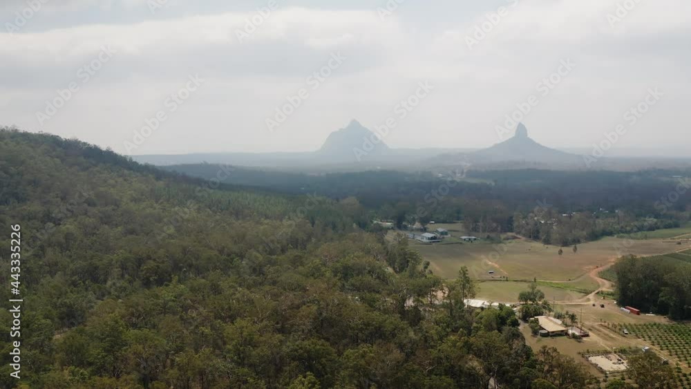 View Of Mountain Coonowrin With A Residential House In Sunshine Coast Region Of Queensland, Australia - aerial drone shot View Of Mountain Coonowrin With A Residential House In Sunshine Coast Region Of Queensland, Australia - aerial drone shot