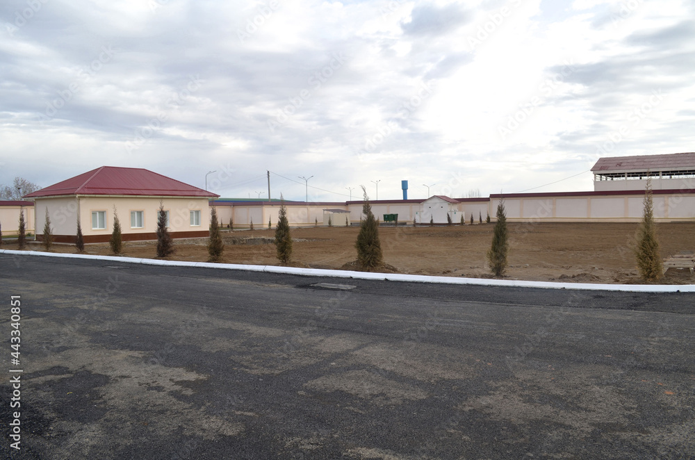 Territory is in an industrial zone fenced with a large plot of land and a one story building