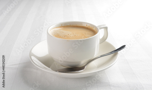 a cup of hot cafe coffee with fresh milk on white background halal beverage menu