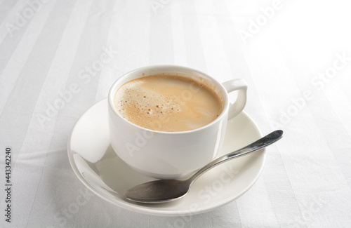 a cup of hot cafe coffee with fresh milk on white background halal beverage menu