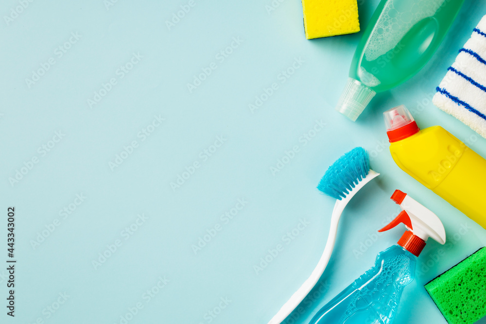 Cleaning concept. Set of cleaning supplies on blue background with copy