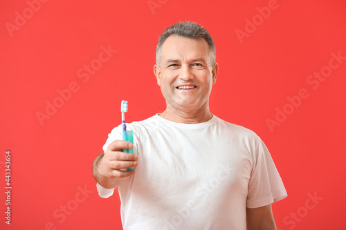 Mature man with tooth brush...