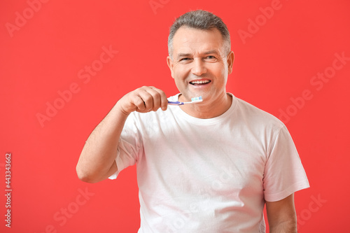 Mature man brushing teeth o...