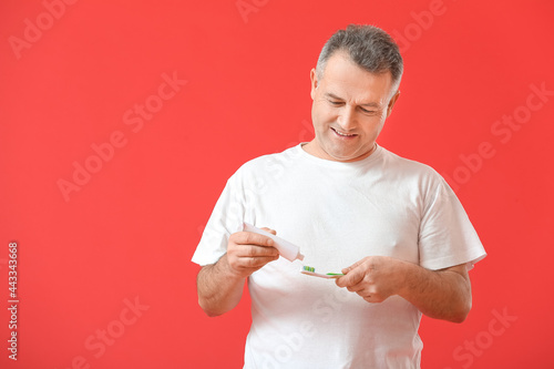 Mature man brushing teeth o...
