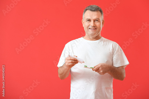 Mature man brushing teeth o...