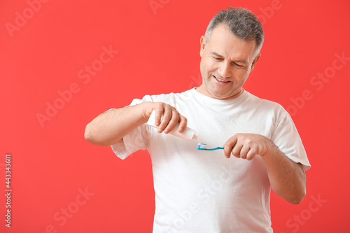 Mature man brushing teeth o...