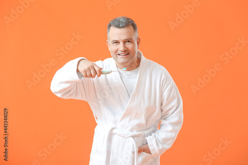 Mature man brushing teeth o...