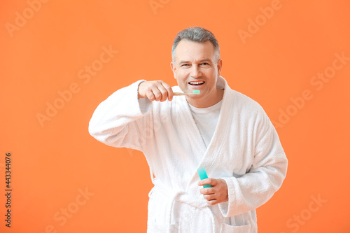 Mature man brushing teeth o...
