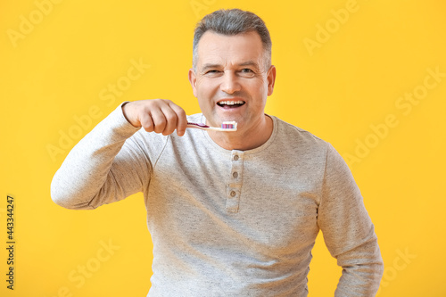 Mature man brushing teeth o...