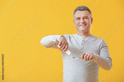 Mature man brushing teeth o...