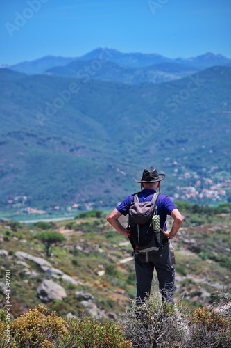 Rear view of senior man with backpack hiking