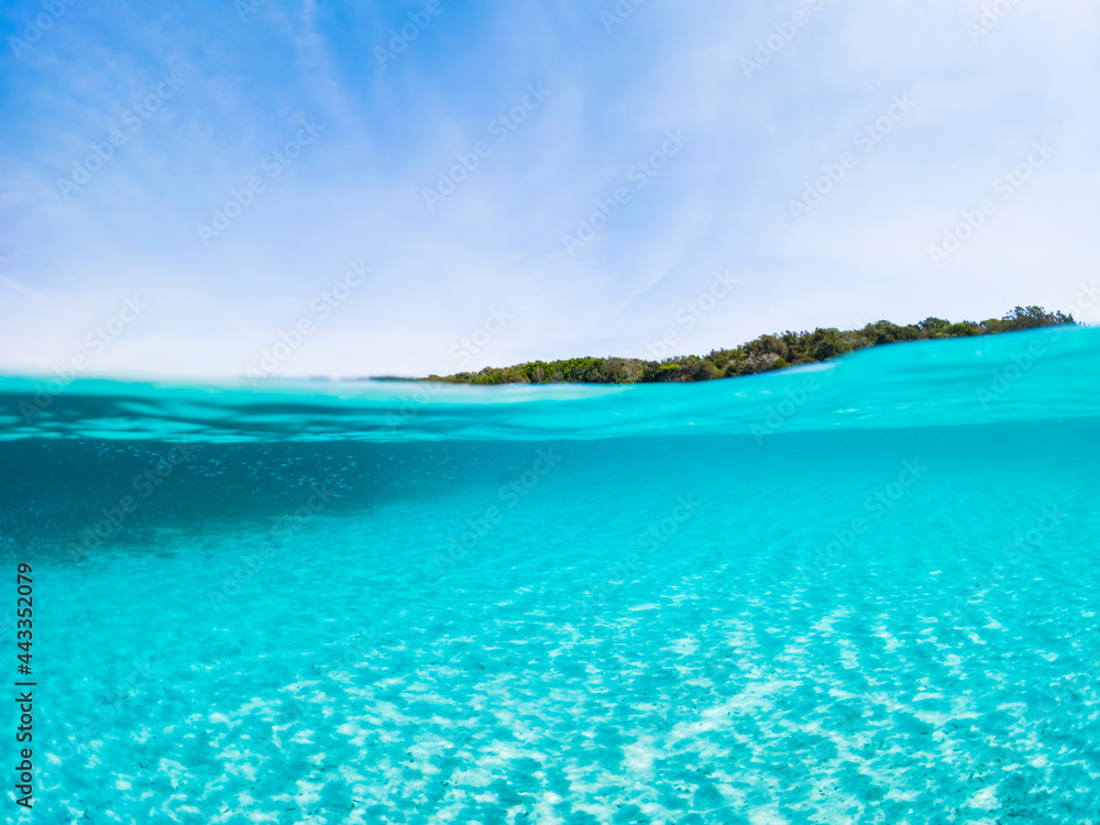 (Selective focus) Stunning view of half underwater sea and half blue sky. La Maddalena Archipelago, Sardinia, Italy. Concept, split, fifty fifty, natural background with copy space.