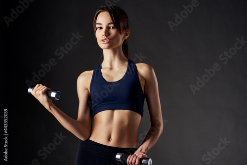 cute brunette with dumbbells in hand pumping workout muscles © SHOTPRIME STUDIO