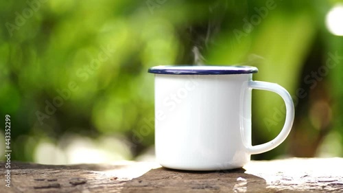 Wallpaper Mural white enamel coffee mug on the old wooden table green forest bokeh background Torontodigital.ca