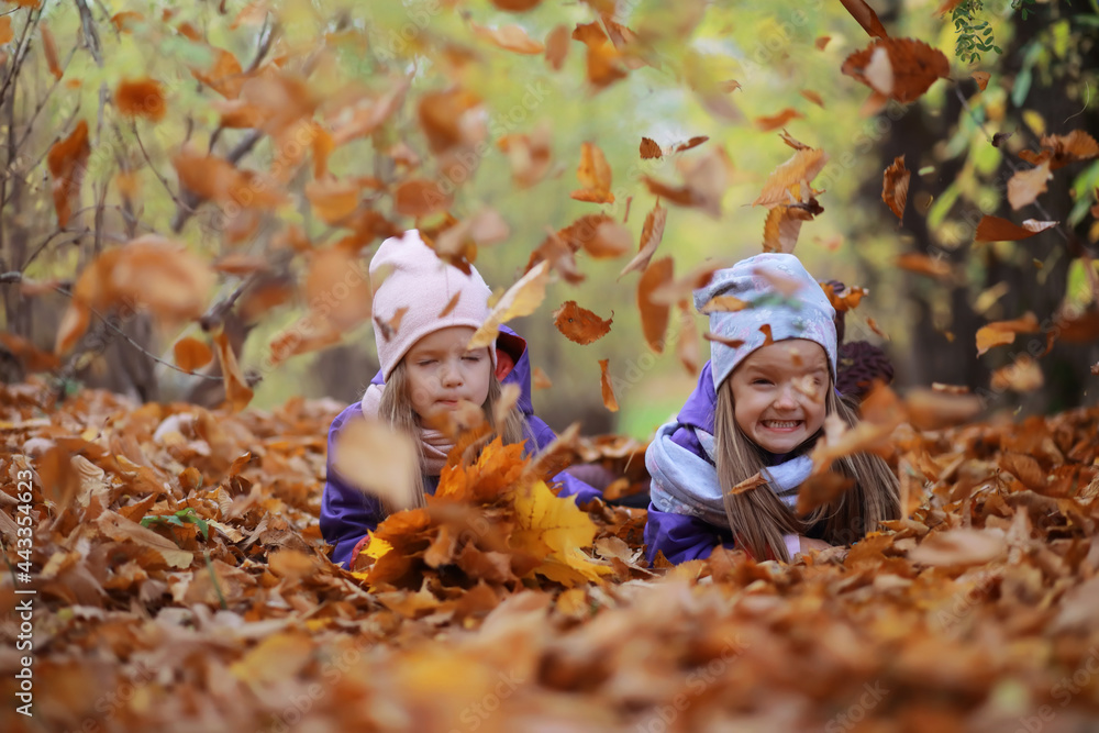 Young family on a walk in the autumn park on a sunny day. Happiness to be together. Young family on a walk in the autumn park on a sunny day. Happiness to be together.
