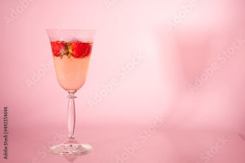 a glass of champaign and strawberries