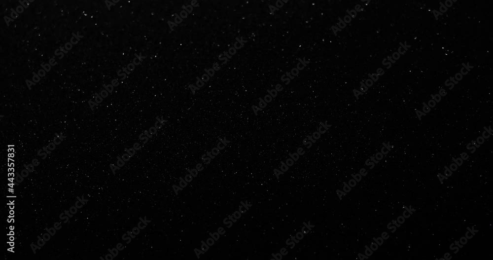 Silver glitter black sand or diamond dust creating abstract shimmering glow formations blinking metamorphosis. Art background texture glamour Silver glitter black sand or diamond dust creating abstract shimmering glow formations blinking metamorphosis. Art background texture glamour