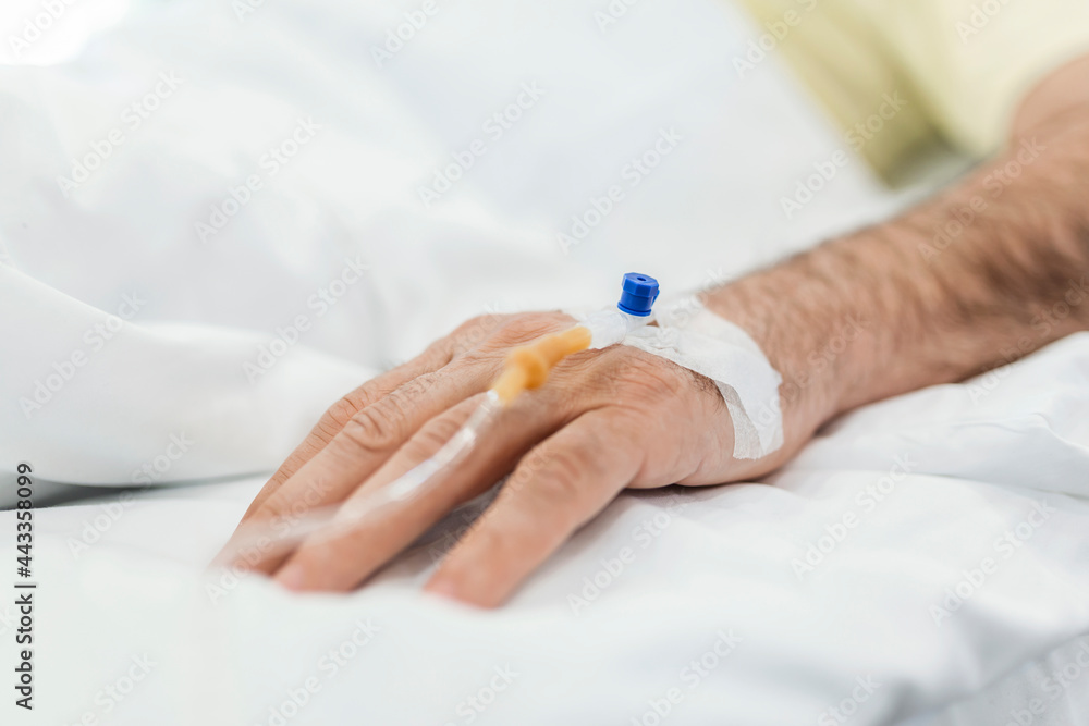 Cropped image of IV drip on patient hand. Cropped image of IV drip on patient hand.