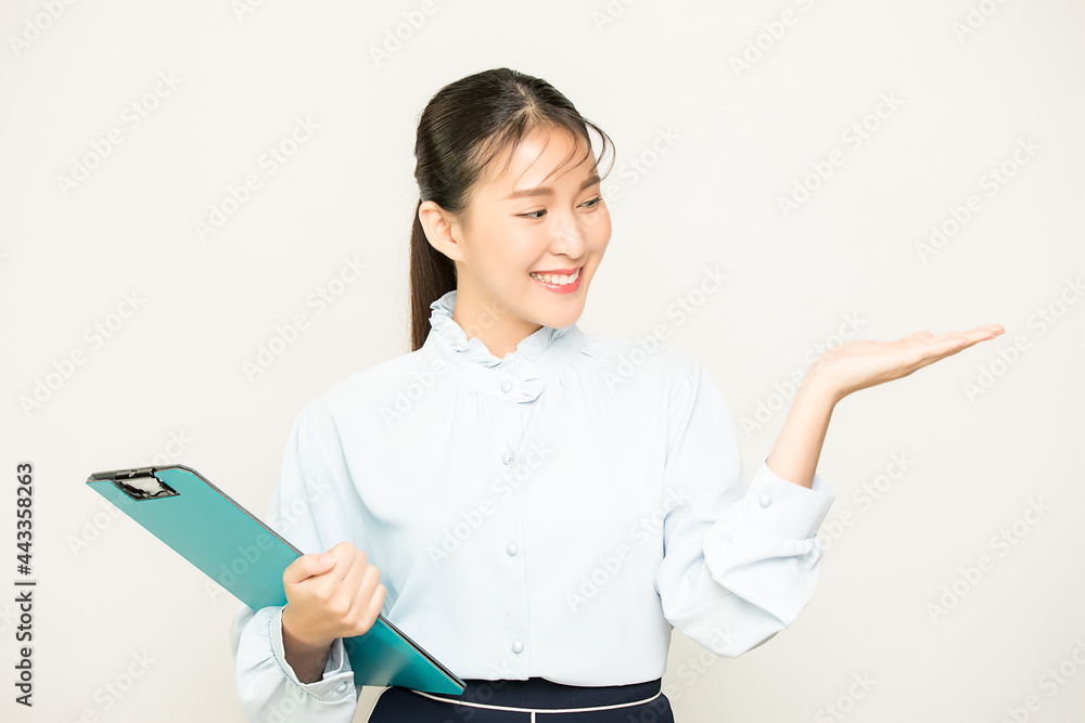Portrait of pretty female office worker, business woman person showing something with business file material in isolate empty background Portrait of pretty female office worker, business woman person showing something with business file material in isolate empty background