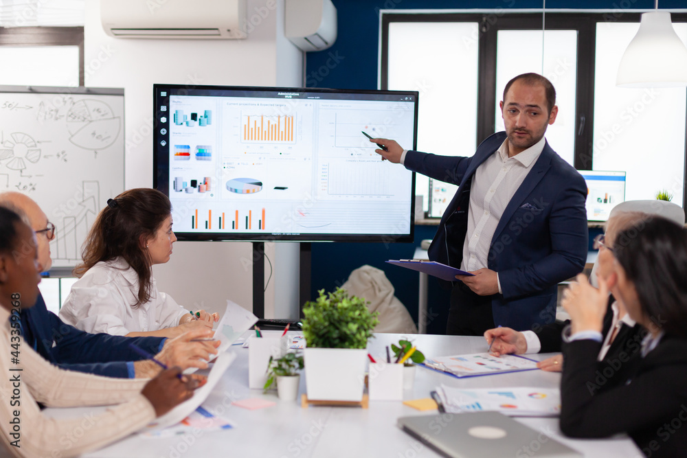 Manager Briefing Manager holding briefing presentation in conference room monitor ...