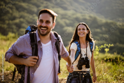 Happy couple is hiking in mountain. photo