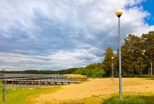 Jetty pier and public beach at Necko lake shore in Masuria lake district resort town of Augustow in Podlaskie voivodship of Poland photo