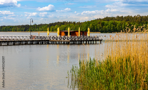 Fototapeta Naklejka Na Ścianę i Meble -  Jetty pier and public beach at Necko lake shore in Masuria lake district resort town of Augustow in Podlaskie voivodship of Poland