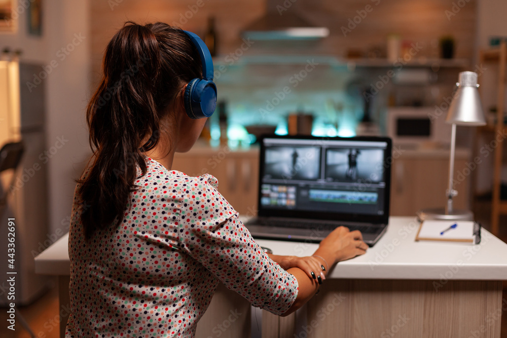 Woman working with video footage on laptop using modern software. Content  creator in home working on montage of film using modern software for  editing late at night. Stock-Foto | Adobe Stock