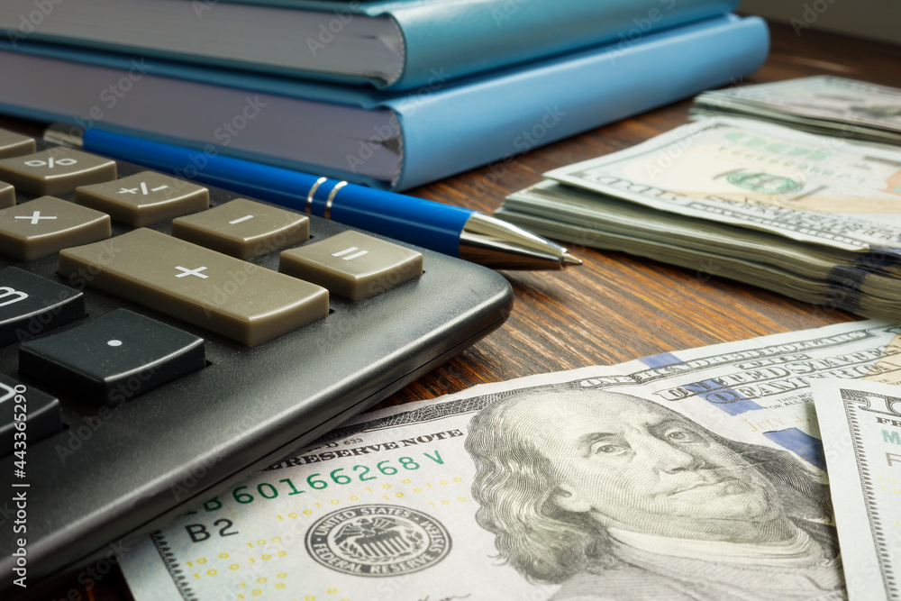 Personal savings and finances. Calculator and money on the table. Personal savings and finances. Calculator and money on the table.