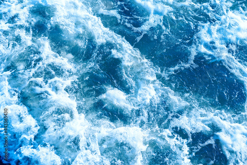 Deep blue and rough sea with lot of sea spray.Blue background.Soft focus,blurred image.