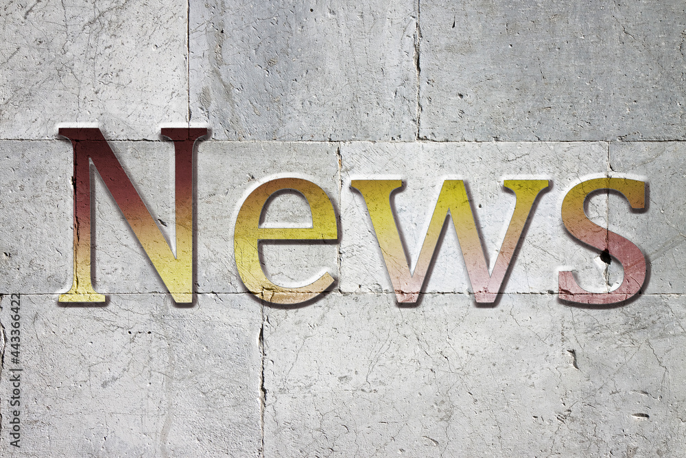 News carved on white stone wall News carved on white stone wall