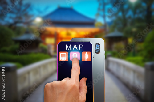 Map apps in phone. Smartphone with online maps application. Online cards for mobile phone. Hand with smartphone on background at home. Blurred house in background. Person chooses apps for navigation
