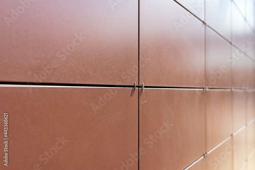 Background texture of rectangular smooth brown tiles. Stone street covering of wall, masonry of building. © ARVD73