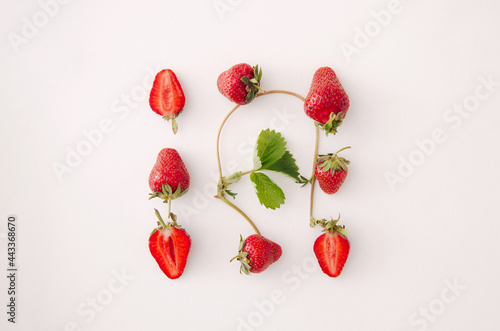 Fresh red strawberry fruit and leaf on white background. Top view, flat lay, square.