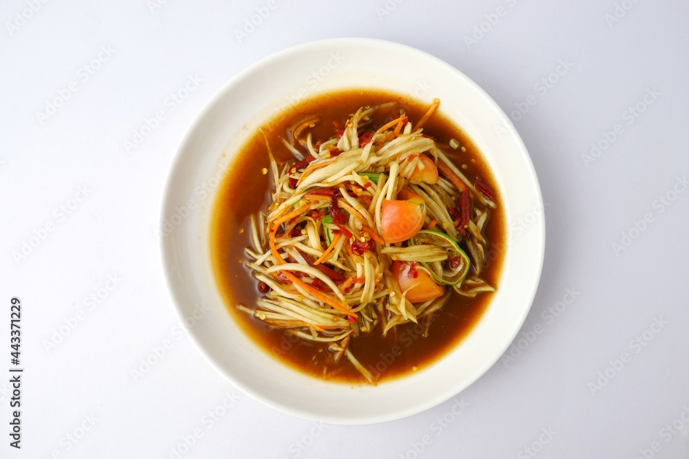 papaya salad,Raw papaya mixed lemon chili, tomato and garlic, an ingredient in papaya salad on white dish on white background papaya salad,Raw papaya mixed lemon chili, tomato and garlic, an ingredient in papaya salad on white dish on white background