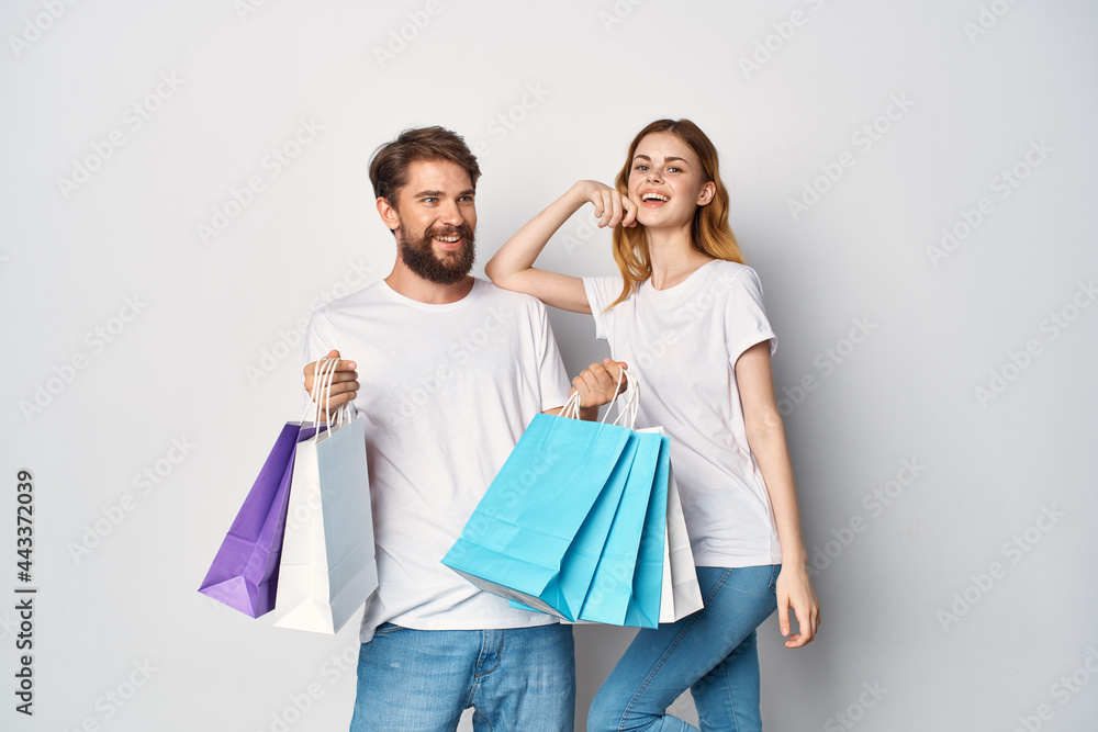 young couple killed in t-shirts with packages in their hands lifestyle shopping young couple killed in t-shirts with packages in their hands lifestyle shopping