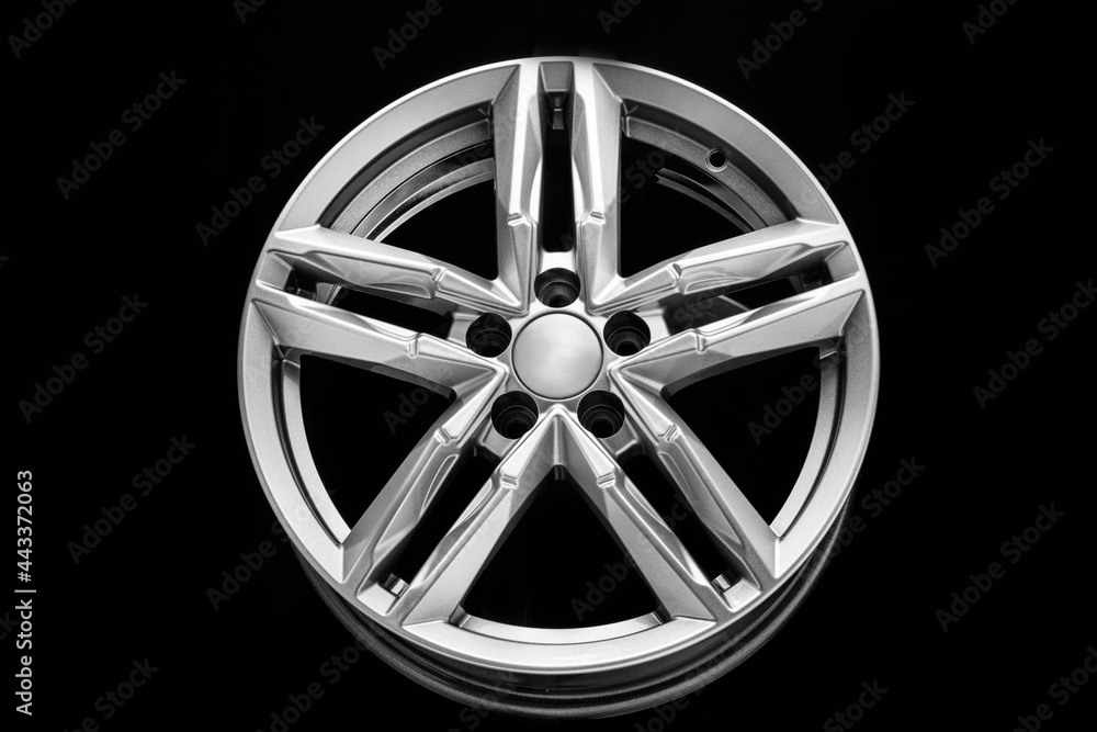 silver alloy wheel with bifurcated beams on a black background
