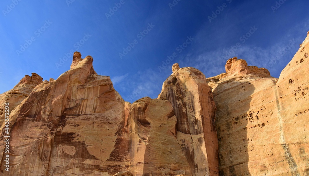 Fototapeta premium steep cliffs above the head of sinbad native american pictographs on a sunny day in the san rafael swell near green river, utah