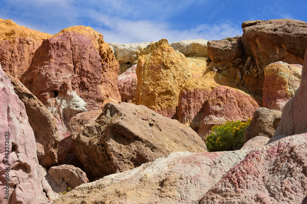 the incredibly colorful  pink and yellow eroded hoodoo rock formations of the paint mines interpretive park in winter, near calhan, colorado