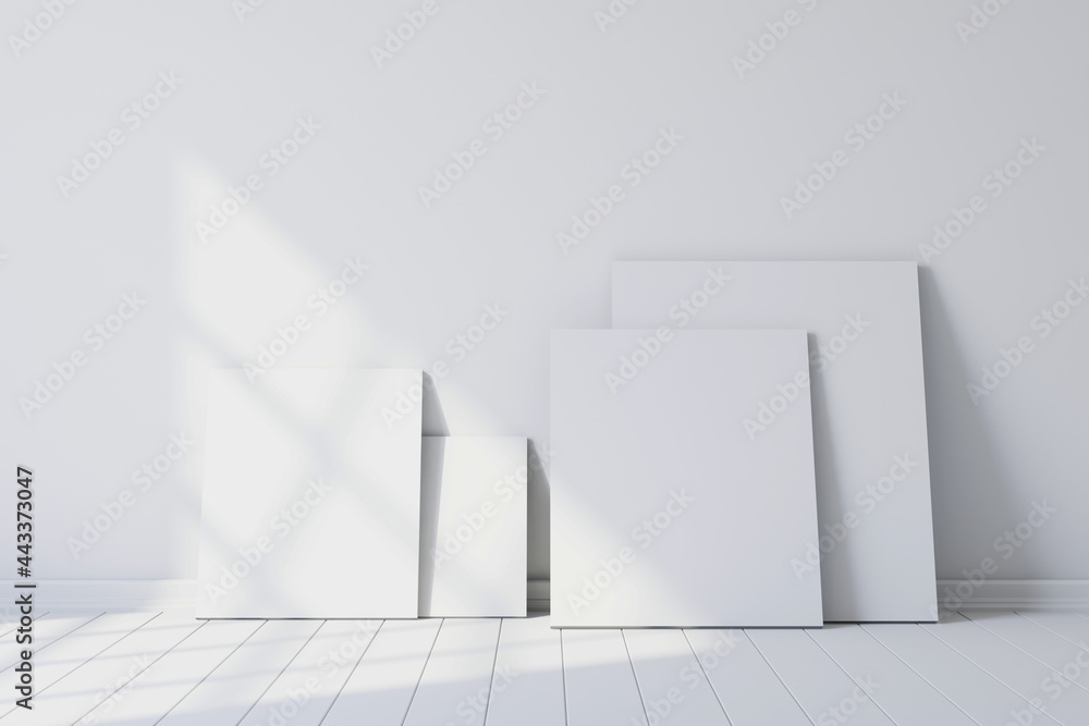 Fototapeta premium Blank canvases of paintings in an empty white room. 3d rendering