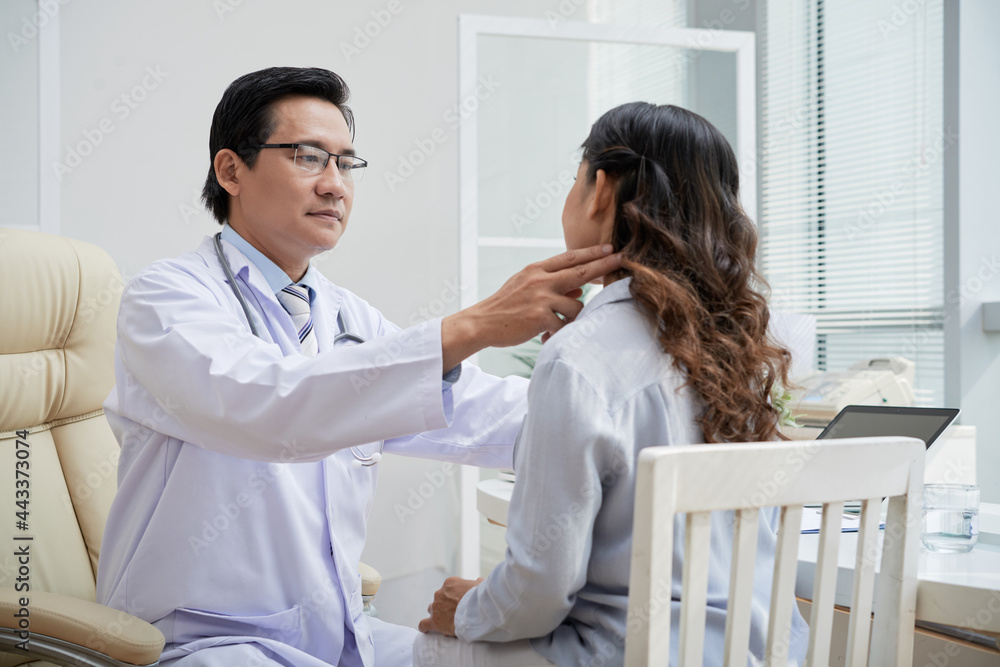General practitioner touching neck of senior patient when checking her pulse and palpating lymph nodes General practitioner touching neck of senior patient when checking her pulse and palpating lymph nodes